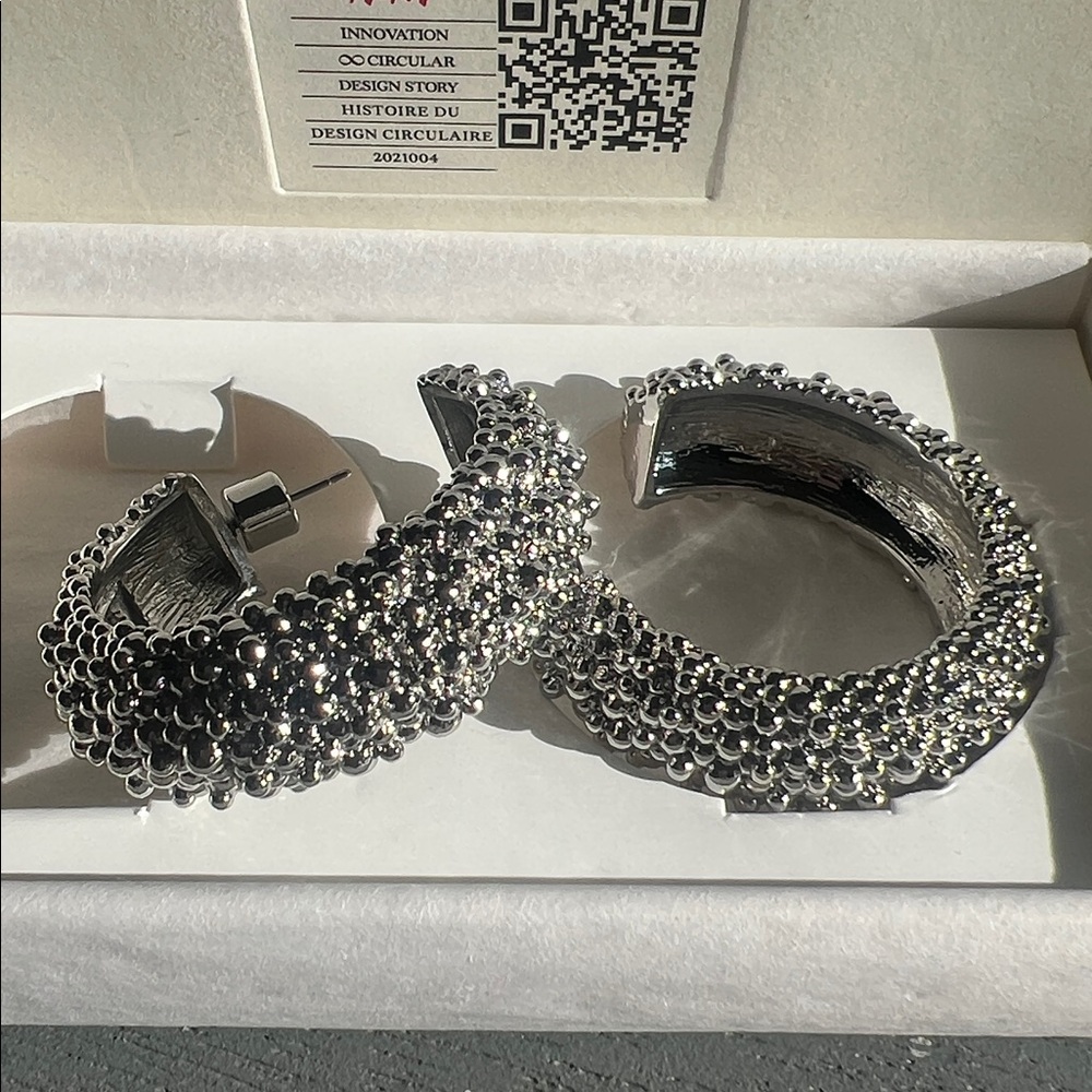 Circular design story silver hoop earrings
